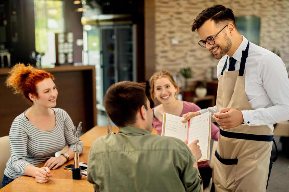 Server presenting a menu to guests.