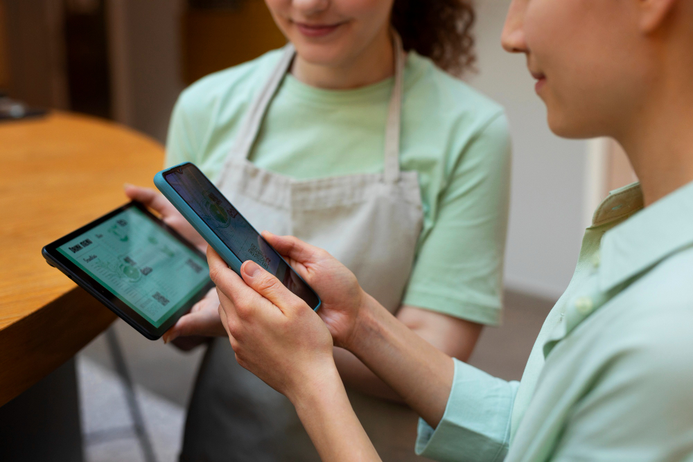 Team members reviewing orders on a tablet.